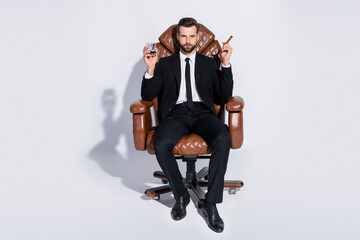 Full body photo of handsome business guy sit big office chair hold whiskey glass cuban cigar luxury...