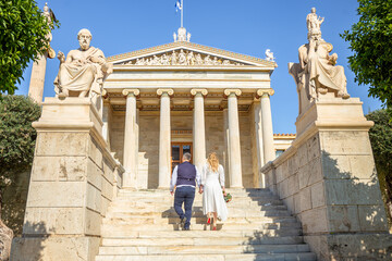 Beautiful wedding couple in Athens, Greece. Look at the classical architecture of University, the view from the back