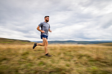 handsome trail runner running in nature