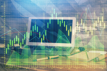 Double exposure of forex graph and work space with computer. Concept of international online trading.