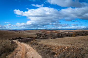 Landscape of the dry Castilian fields with a cloudy blue sky in winter, Atienza, Guadalajara, Spain
