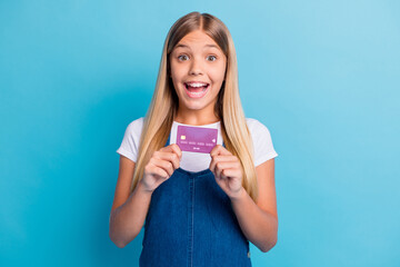 Portrait of surprised nice blond long hair girl showing credit card wear casual outfit isolated on...