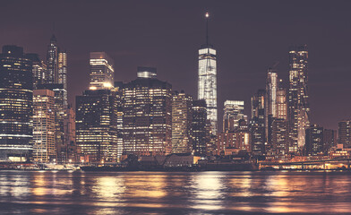 New York City Manhattan downtown skyline at night, color toning applied, USA.