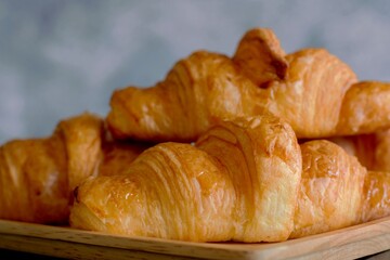 croissants on the bakery table after baked from the oven, ready to serve or sell at the bakery shop or coffee cafe