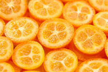 kumquat citrus fruit slices background