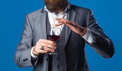 Red wine. Man in suit drinks wine. Alcohol. Wine. Glass of wine. Man with Bordeaux. Tasting alcohol.