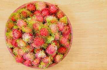 Top view image of rambutan in the food tray on the table