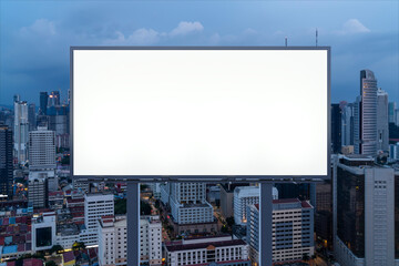 Blank white road billboard with KL cityscape background at night time. Street advertising poster, mock up, 3D rendering. Front view. The concept of marketing communication to promote or sell idea.