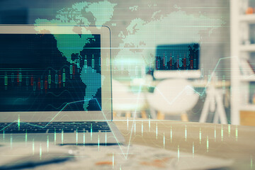 Double exposure of graph and financial info and work space with computer background. Concept of...