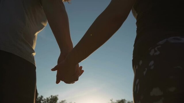 Guy and a girl holding hands on a sunny day
