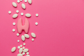 Human thyroid gland on a pink background. Treatment and prevention of the endocrine system. Symptoms of the disease and inflammation.