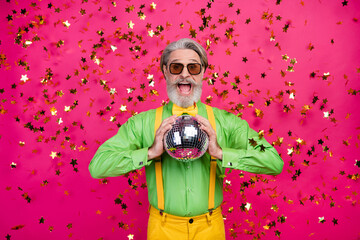 Photo of funny grandpa party club confetti fall excited open mouth hold glowing disco ball wear sun...