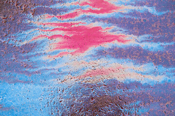 Abstract multicolored stain of gasoline on the asphalt