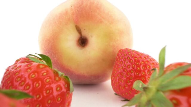 close-up. peach, strawberry and butt plug isolated on white background.