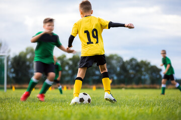 Boys in soccer clubs compete in outdoor tournament match. Football game for school kids. Children...