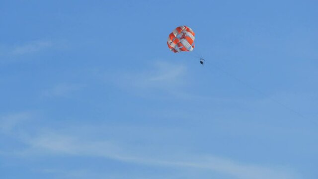 People are resting flying on parasailing over the Adriatic Sea in the Bay of Kotor, Montenegro, outdoor activities.