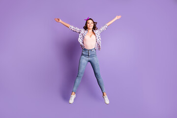 Fototapeta na wymiar Full length photo portrait of sweet charming brown hair girl wear retro plaid shirt jumping isolated purple color background