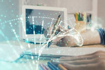 DNA theme hologram over woman's hands writing background. Concept of education. Double exposure