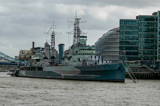 From the other bank of the Thames is the imposing HMS Belfast, the historic warship. Photograph taken in London, England, United Kingdom.