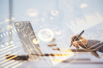 Technology theme hologram with man working on computer on background. High tech concept. Double exposure.