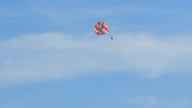 People are resting flying on parasailing in the sky, outdoor activities.