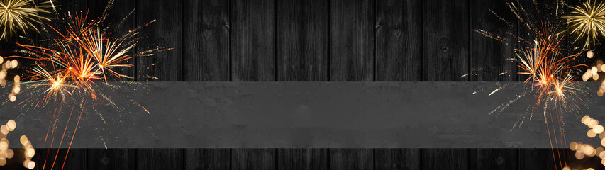 Festive Silvester / New Year / background banner panorama long- Firework and bokeh lights on rustic wooden texture, with gray empty banner, with space for text