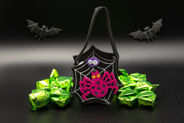 Halloween composition set with Candy Bags Cute Felt Pouches with Handles, Trick or Treat Goody Bags, bats on black background.