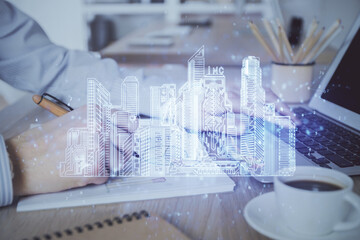 High tech city drawing with businessman working on computer on background. Smartcity concept. Double exposure.