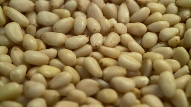 Pine nuts spinning around. Close up