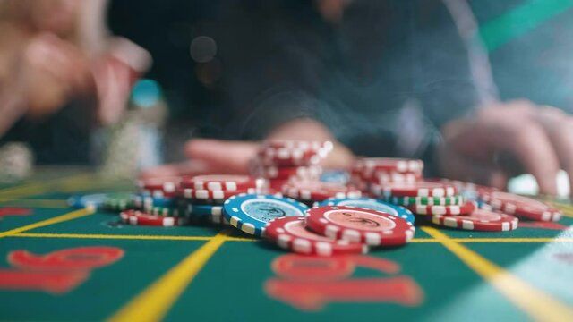 Risky man betting all chips in while playing in casino