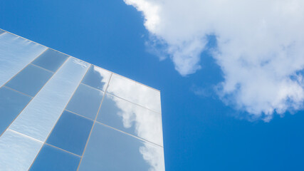 Fototapeta na wymiar glass structure with blue sky and clouds on the background