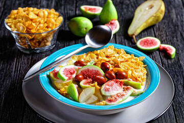 Healthy breakfast: yogurt, corn flakes, figs, pear