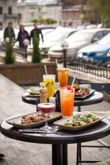 lunch dishes and cocktails served on the table street food cafe summer outside
