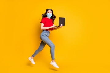 Full length profile side photo of girl work laptop internet sale jump run wear mask t-shirt denim isolated yellow color background
