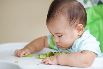 Cute Baby Eating On The Baby Chair