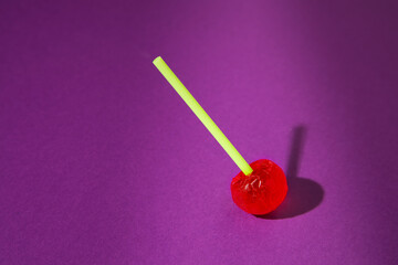 red lollipop on purple background