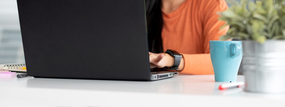 close up woman hand of content creator typing on laptop working from home.new normal lifestyle using technology