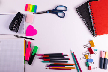 different stationary items of various colours on light surface.