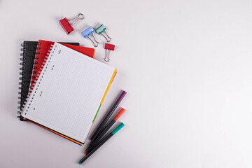 different stationary items of various colours on light surface.