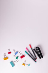 different stationary items of various colours on light surface.