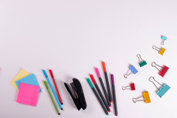 different stationary items of various colours on light surface.