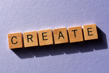 Create, word in wooden alphabet letters isolated on purple background