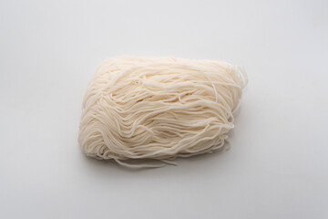 Raw Vietnamese noodle on a white background, uncooked, preserve.