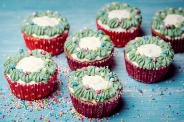Very nice composition of cupcakes and cakepops with deocrations, colorful, blue background