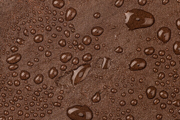 A natural stone covered with a protective liquid from moisture and mold. Protect the stone from moisture. Drops of water on a rock. Hydrophobicity.
