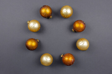 Christmas or new year composition. Round frame made of Christmas balls on a black background. Holiday and celebration concept. Flat Lay. Top view. Copy space.