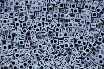 Cluster of white cube-shaped beads with black letters.