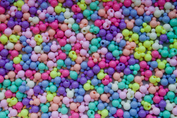 Fototapeta na wymiar Cluster of coloured spheric-shaped beads.