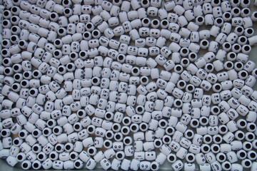 Cluster of white round shaped beads with smiles/faces.