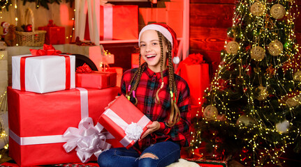 Obraz na płótnie Canvas family holiday time. new year is coming. Kid enjoy the holiday. child girl with xmas present. hello from santa claus. surprise. small happy girl at christmas tree. morning before Xmas